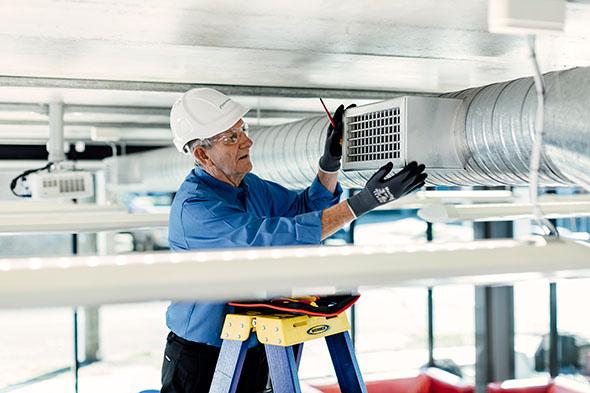 man servicing hvac system