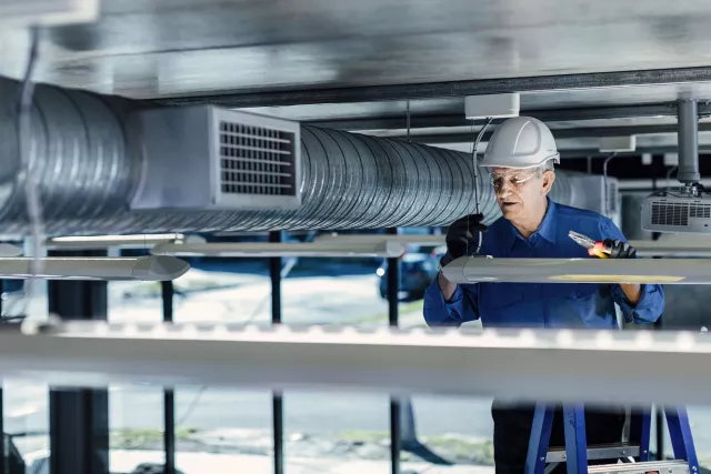 Man servicing air conditioning unit
